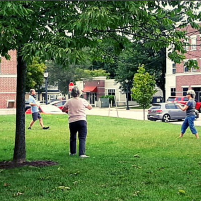 Nancy Osley and 2 adults doing Qigong at the Village Green