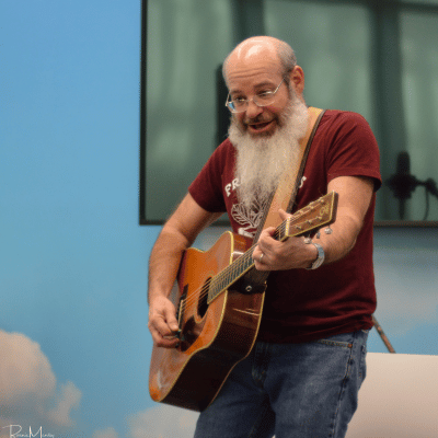 David Landau singing and playing the acoustic guitar