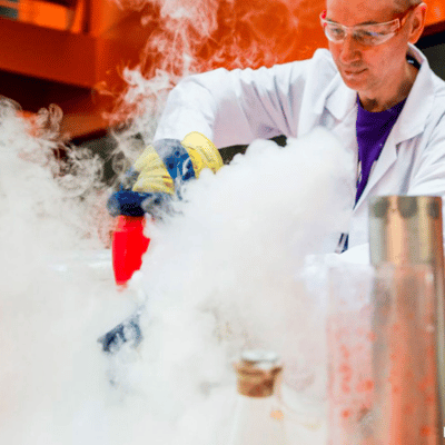 A scientist from Mad Science of Milwaukee surrounded by fog as a result of an experiment.