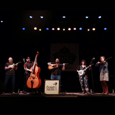 The group Soggy Prairie performing on a stage